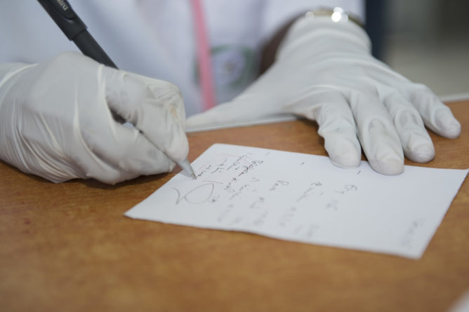 150317-F-QZ836-017 DJIBOUTI (March 17,2015)A medical technician writes out a prescription for a patient during the Djibouti Ministry of Health Medical Caravan to the Yoboki Medical Clinic, Mar 17. Physicians from Combine Joint Task Force-Horn of Africa, Djibouti Ministry of Health and United States Agency for International Development, provided medical care during a Medical Caravan in DjiboutiÕs Dikhil region. (U.S. Air Force photo by Staff Sgt. Carlin Leslie/Released)